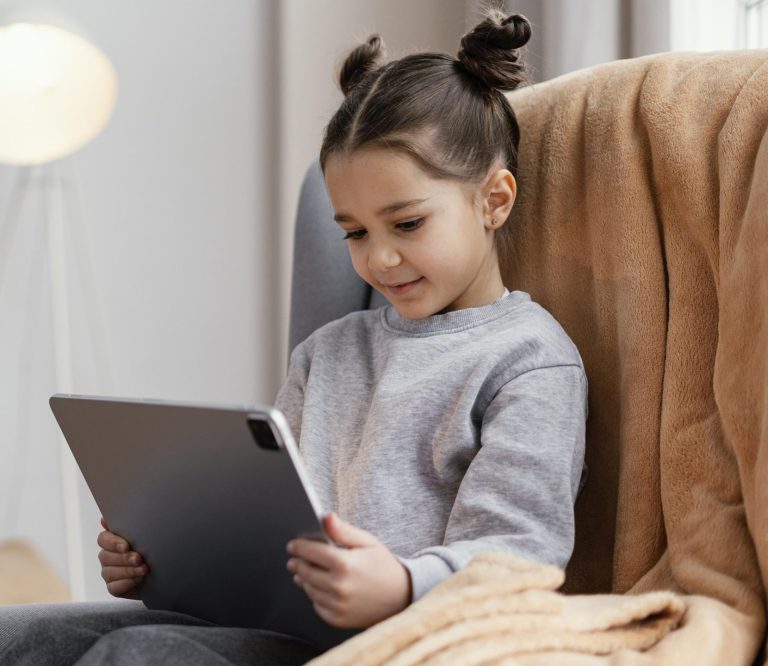 little-girl-couch-using-tablet